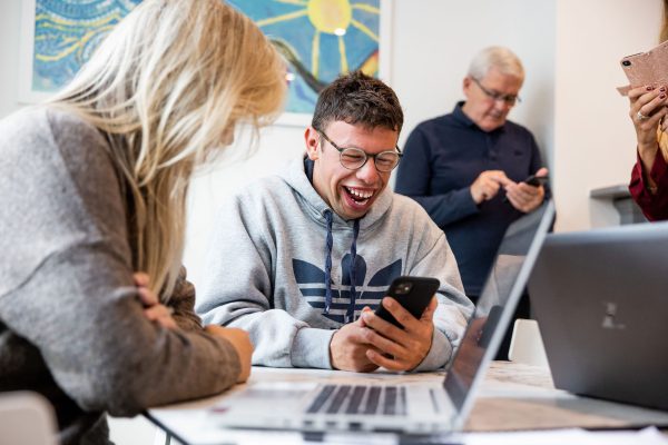 Customer laughing looking at website on his phone