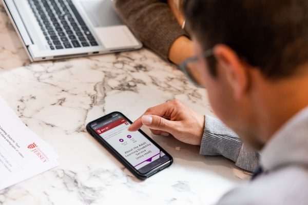 Customer looks at website on mobile phone on table