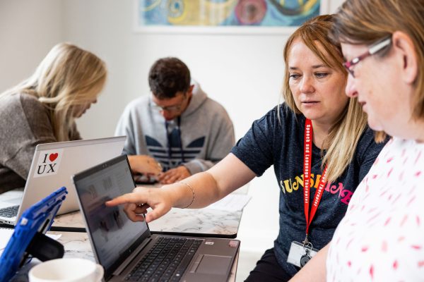 People looking at a laptop