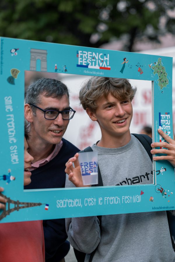 Two people taking a picture within a photo frame