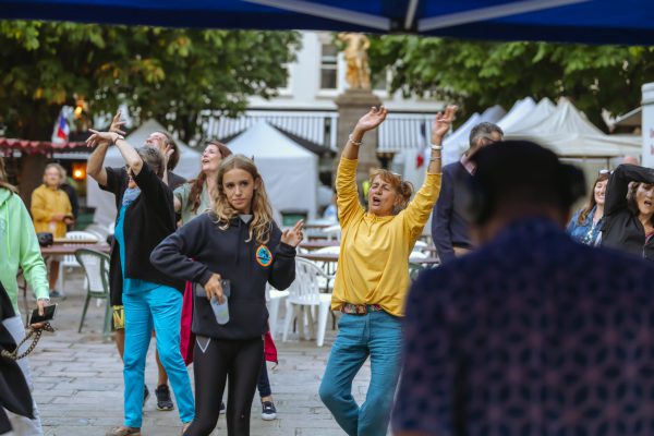 a group of individuals dancing in the Royal Square